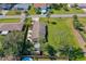 Birds eye view showing a shaded back patio, green trees, and a storage shed at 3403 Kumquat Dr, Edgewater, FL 32141