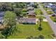 Aerial view of home featuring a well manicured yard, mature landscaping, and a charming facade at 3403 Kumquat Dr, Edgewater, FL 32141