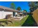 Backyard with a patio area with a dining set, and a fenced yard at 3403 Kumquat Dr, Edgewater, FL 32141