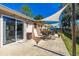 Backyard patio with dining set and shade covering at 3403 Kumquat Dr, Edgewater, FL 32141