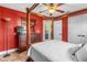 Bedroom with a canopy bed, ceiling fan, and stylish decor create a warm ambiance at 3403 Kumquat Dr, Edgewater, FL 32141