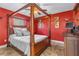 Bedroom with a canopy bed, ceiling fan, and stylish decor create a warm ambiance at 3403 Kumquat Dr, Edgewater, FL 32141
