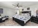 Comfortable bedroom featuring a ceiling fan, stylish furnishings, and a calming color palette at 3403 Kumquat Dr, Edgewater, FL 32141