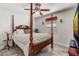 Bright bedroom featuring a four-poster bed, a large window and wood-look floors at 3403 Kumquat Dr, Edgewater, FL 32141