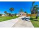Long driveway to a charming home with a well-kept lawn and mature palm trees enhancing curb appeal at 3403 Kumquat Dr, Edgewater, FL 32141