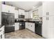 Well-equipped kitchen with stainless steel appliances, sleek black countertops, and ample white cabinetry at 3403 Kumquat Dr, Edgewater, FL 32141