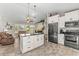 Open-concept kitchen featuring an island, stainless steel appliances, and seamless connection to the living area at 3403 Kumquat Dr, Edgewater, FL 32141