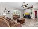 Inviting living room featuring a plush sofa, cozy armchair, entertainment center, and sun-filled bay window at 3403 Kumquat Dr, Edgewater, FL 32141