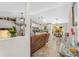 Bright open-concept space featuring wood flooring, a comfortable sofa, and seamless flow to the dining and kitchen areas at 3403 Kumquat Dr, Edgewater, FL 32141