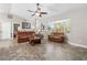 Spacious living room features wood flooring, comfortable seating, and a bright, airy atmosphere at 3403 Kumquat Dr, Edgewater, FL 32141