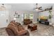 Inviting living room featuring a plush sofa, cozy armchair, entertainment center, and sun-filled bay window at 3403 Kumquat Dr, Edgewater, FL 32141