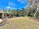 Expansive lawn is enhanced by the mature landscaping, rock border, and mulched garden beds at 3435 Black Willow Trl, Deland, FL 32724
