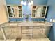 Bathroom with a double sink vanity with granite countertop, cabinets, and tiled flooring at 3435 Black Willow Trl, Deland, FL 32724