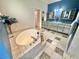 Bathroom with a tub, walk-in closet, a double sink vanity, and tiled flooring at 3435 Black Willow Trl, Deland, FL 32724