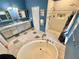 Bathroom with a tub, tiled shower, and a double sink vanity with a granite countertop at 3435 Black Willow Trl, Deland, FL 32724