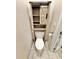 Cozy bathroom features an over-the-toilet cabinet with a sliding barn door for a rustic touch at 3435 Black Willow Trl, Deland, FL 32724