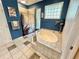 Bathroom featuring a tub with a tiled shower, and a window with blinds at 3435 Black Willow Trl, Deland, FL 32724