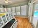 Cozy bedroom features a bunk bed, hardwood floors, and view of the pool at 3435 Black Willow Trl, Deland, FL 32724