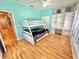 Charming bedroom features a bunk bed, built-in desk, and hardwood floors at 3435 Black Willow Trl, Deland, FL 32724