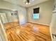 Bright bedroom with hardwood floors, a ceiling fan, and mirrored closet doors at 3435 Black Willow Trl, Deland, FL 32724