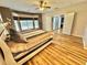 A spacious primary bedroom with hardwood floors, a ceiling fan, and white trim bay windows at 3435 Black Willow Trl, Deland, FL 32724