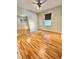 This bedroom features hardwood floors, a ceiling fan, and a mirrored closet at 3435 Black Willow Trl, Deland, FL 32724