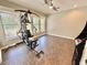 Bonus room boasts natural lighting from large windows, an arcade game, and a ceiling fan at 3435 Black Willow Trl, Deland, FL 32724
