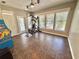 Bonus room with ceiling fans and abundant natural light, home gym equipment, and arcade game at 3435 Black Willow Trl, Deland, FL 32724
