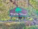 Trails West community sign with lush landscaping, creating a welcoming entrance at 3435 Black Willow Trl, Deland, FL 32724