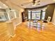 Dining room features large windows, dark wood table and hardwood floors at 3435 Black Willow Trl, Deland, FL 32724
