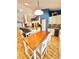 Bright dining area featuring a wooden table with white chairs and modern lighting fixtures at 3435 Black Willow Trl, Deland, FL 32724