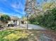 Home featuring a lengthy driveway and basketball court along the side, perfect for recreational activities at 3435 Black Willow Trl, Deland, FL 32724