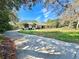 Well-maintained home featuring a large front yard, lush trees, and colorful landscaping at 3435 Black Willow Trl, Deland, FL 32724