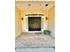Welcoming front porch with a double-door entry and brick flooring accented by flower pot at 3435 Black Willow Trl, Deland, FL 32724