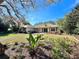 Charming home with a well-manicured lawn and colorful landscaping under a bright blue sky at 3435 Black Willow Trl, Deland, FL 32724