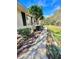 Home exterior featuring a stone-lined walkway surrounded by lush landscaping and a manicured lawn at 3435 Black Willow Trl, Deland, FL 32724