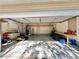 Spacious garage featuring ample storage, work area, and room for parking with lawn equipment at 3435 Black Willow Trl, Deland, FL 32724