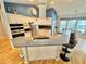 Bright open concept kitchen with island seating, white cabinetry, and a view to the backyard at 3435 Black Willow Trl, Deland, FL 32724