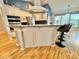 Kitchen island with bar stool seating, modern fixtures, and white cabinetry at 3435 Black Willow Trl, Deland, FL 32724