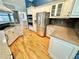 Well-lit kitchen with stainless steel appliances, white cabinetry, and granite countertops at 3435 Black Willow Trl, Deland, FL 32724
