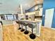 Open concept kitchen with island seating, stainless steel appliances, and white cabinets at 3435 Black Willow Trl, Deland, FL 32724