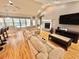 Open living space with hardwood floors, modern kitchen bar, fireplace, and sectional sofa at 3435 Black Willow Trl, Deland, FL 32724