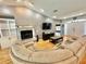 Bright living room featuring a brick fireplace, built-in shelves, and a comfy sectional sofa at 3435 Black Willow Trl, Deland, FL 32724