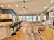 Open living space with hardwood floors, modern kitchen bar, fireplace, and views to the pool at 3435 Black Willow Trl, Deland, FL 32724