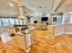 Open concept living room and kitchen area with hard wood floors at 3435 Black Willow Trl, Deland, FL 32724