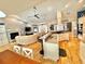 Open concept living room with fireplace, breakfast bar, kitchen and hardwood floors at 3435 Black Willow Trl, Deland, FL 32724