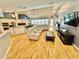 Open-concept living room boasts hardwood floors, large sectional sofa, and views of the pool at 3435 Black Willow Trl, Deland, FL 32724