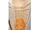 Open walk-in pantry with bright hardwood floors and wire shelving at 3435 Black Willow Trl, Deland, FL 32724
