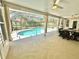 Screened-in lanai overlooking a sparkling swimming pool and outdoor seating area at 3435 Black Willow Trl, Deland, FL 32724