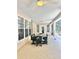 Comfortable screened-in patio offers a large dining table and view to the backyard at 3435 Black Willow Trl, Deland, FL 32724